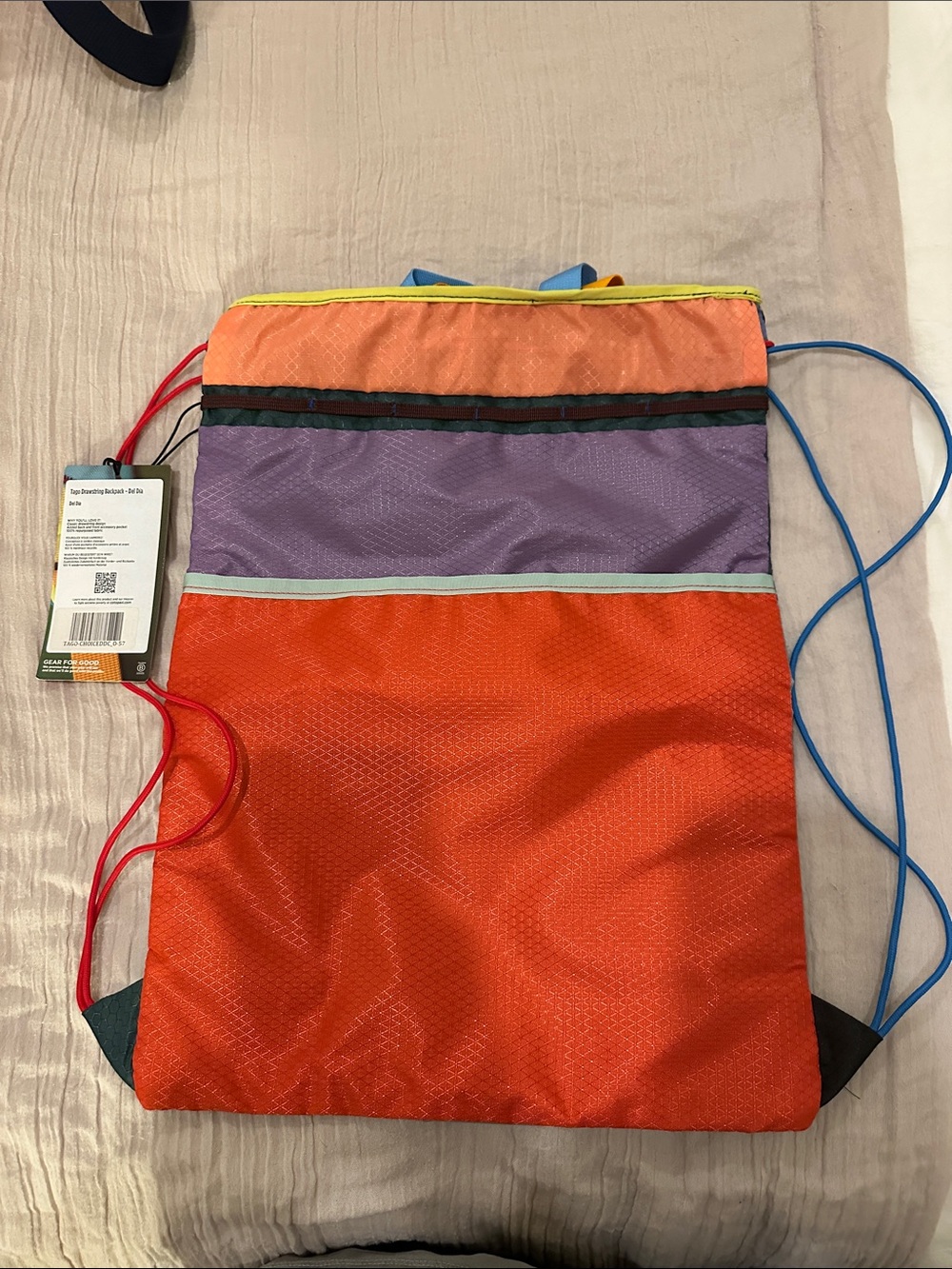 cotopaxi Light Blue Drawstring Pack with Red Logo and Multicolor Accents - Picture 2 of 3